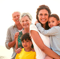 Happy family on the beach smiling after seeing a Cigna dentist in San Antonio